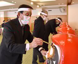 ダルマに目を入れる生産部会役員