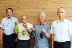 初出荷を報告する生産者と浅沼組合長（右）高栁副組合長（左）