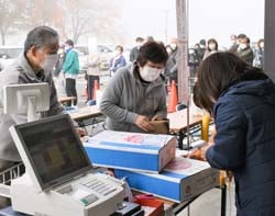 配送手続きするJA職員（右）と来場者（左）（安曇野市豊科）