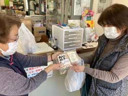 部員に「信州切干大根」「乾燥糸こんにゃく」を手渡す花岡ブロック長（左）