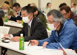 真剣な表情で確認を行う出席者