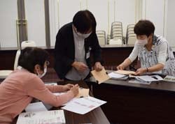 教え合いながら和綴じノートをつくる受講生ら