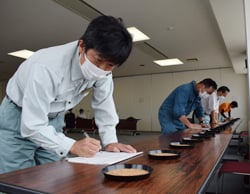真剣な表情で品位鑑定を行う検査員（長野県伊那市で）