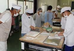 ゆっくり丁寧に蕎麦を切る児童ら