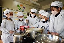 みんなで協力して豆腐をつくる児童たち