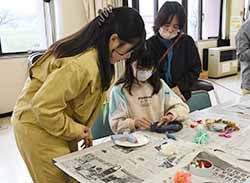 リースに綿を貼り付ける児童