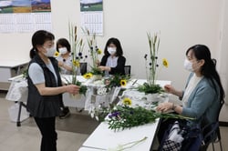 仲山代表（左）に教わりながらアレンジメントを楽しむ参加者