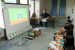 ＪＡブースでスクリーンを見て、JＡについて学ぶ生徒たち
