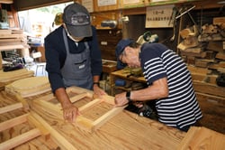 協力して折り畳みテーブルを作る参加者