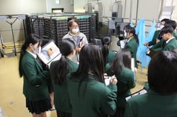 熱心に市田柿工房で説明を聞く生徒ら