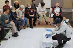 枝豆を植える指導を受ける参加者（１３日、長野県松本市で）