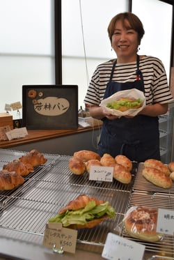 レタスサンドを手にする若林裕美さん（長野県上田市で）