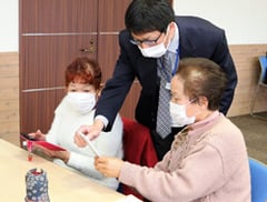 講師からスマホ写真の撮り方を教わる参加者