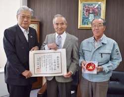 表彰状をうけとる林さんの実弟北澤秀樹さん(中央)