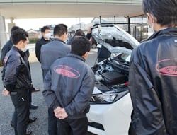 エンジン部分を確認する販売担当者