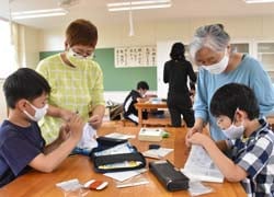 針作業を丁寧に指導する女性部員
