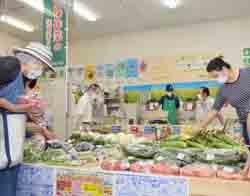 生産者直売コーナーで新鮮な野菜や米を買い求める利用者